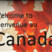 Welcome to Canada billboard with red and orange maple leaves